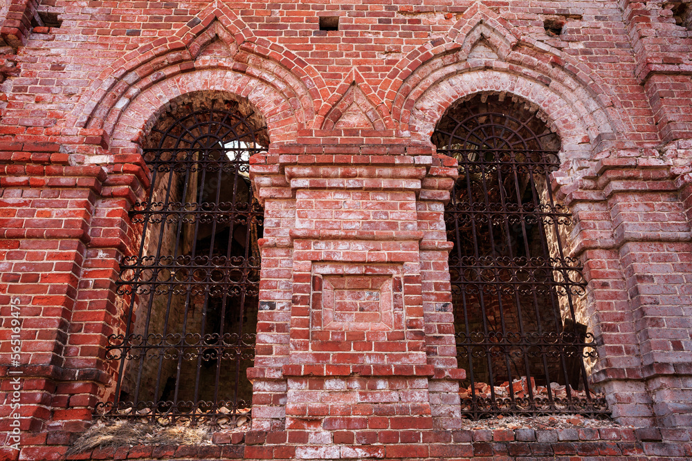 Old ruined temple, red brick church, in the forest, windows with iron bars. Architecture, faith, religion, Orthodoxy. Old ruined temple, red brick church, in the forest, windows with iron bars. Architecture, faith, religion, Orthodoxy.