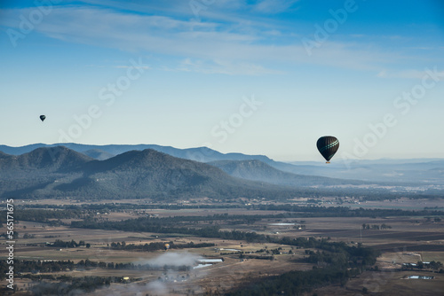 Enjoying travelling with hot air balloon in the clear blue sunrise morning sky for family gathering and school holiday travel destination