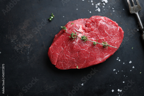 Raw meat with spices and herbs on table