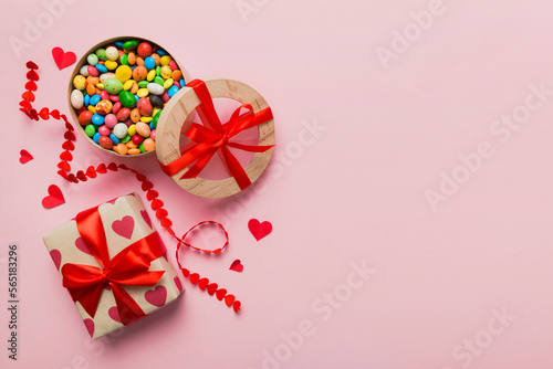 Valentine day composition: sweet candy, with gift boxes with bow and red felt hearts, photo template, background. Top View with copy space © sosiukin