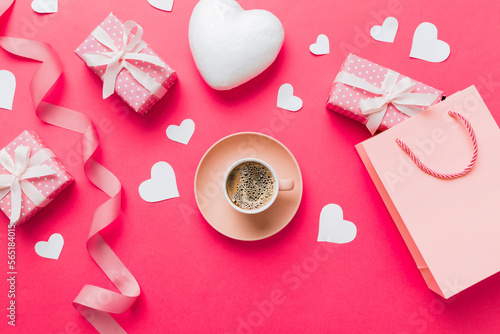 Mug coffee and gift box on colored background. Flat lay composition. Holiday concept © sosiukin