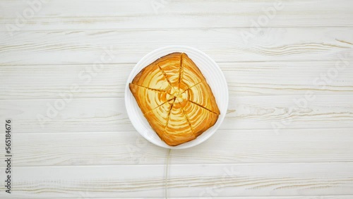 Cottage cheese casserole with pumpkin in a white plate on a white wooden table. Striped casserole with cheese and pumpkin. Cheese pumpkin cake. Cheesecake.