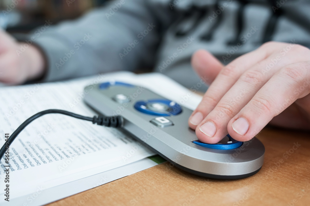 Fototapeta premium A visually impaired man uses a scanning and reading machine.