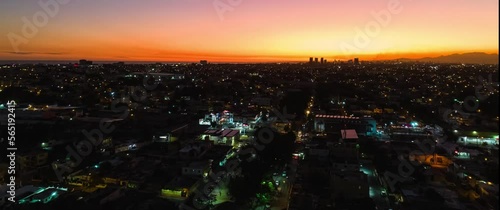 Aerial hyperlapse drone view of city Santo Domingo Este, sunset with the colors of the Caribbean. photo