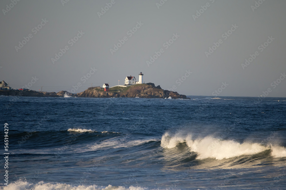 Nubble light with ocean waves in the foreground