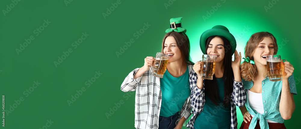 Young women drinking beer on green background with space for text. St. Patrick's Day celebration