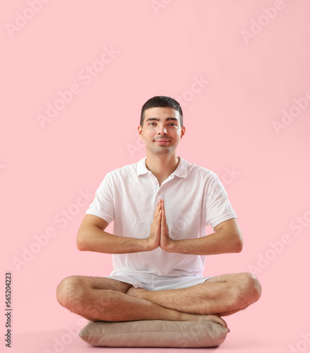Young man meditating on pin...