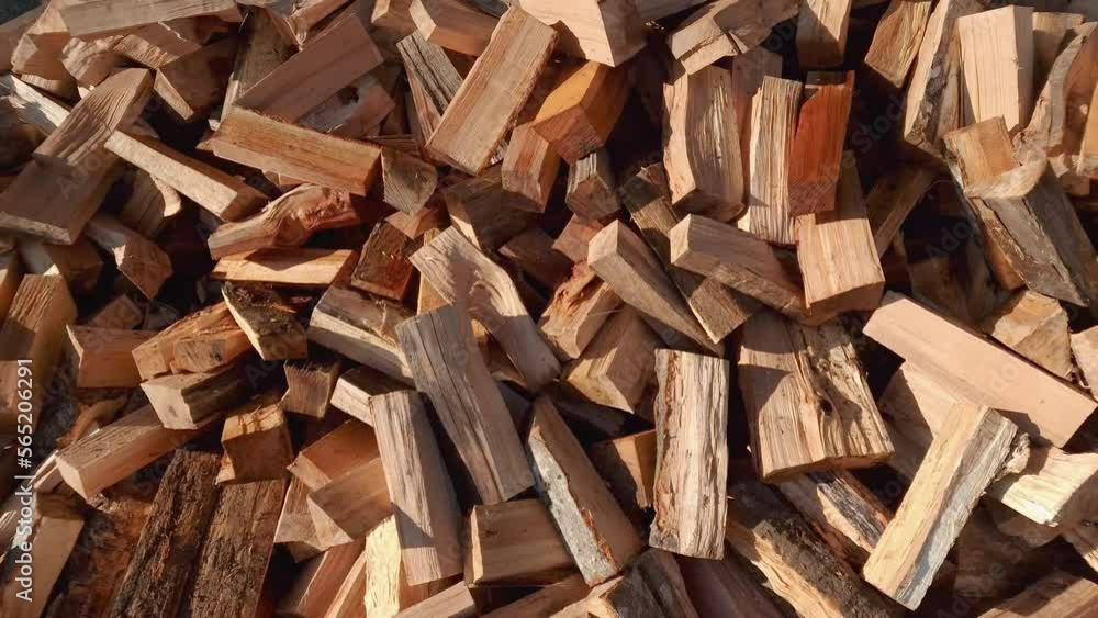 Heap of chopped firewood - woodpile. Pile of split hardwood or softwood as natural resource - wood is renewable energy source mostly used for heating. Heap of chopped firewood - woodpile. Pile of split hardwood or softwood as natural resource - wood is renewable energy source mostly used for heating.