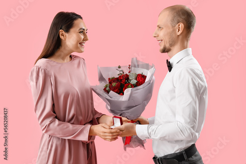 Happy man giving bouquet of...