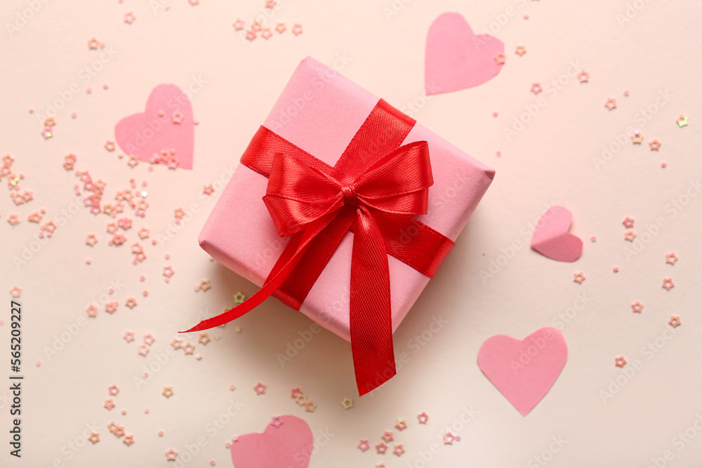 Composition with gift box, paper decor and sequins on color background. Valentine's Day celebration Composition with gift box, paper decor and sequins on color background. Valentine's Day celebration