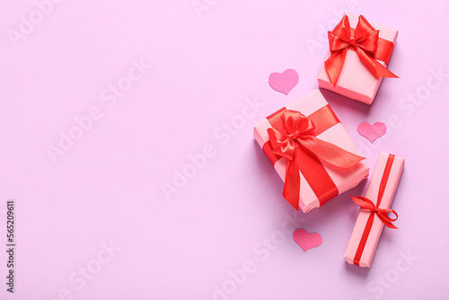 Gift boxes and paper decor on pink background. Valentine's Day celebration