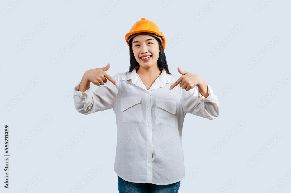 Young female engineer in helmet stand with thumb up posture Young female engineer in helmet stand with thumb up posture