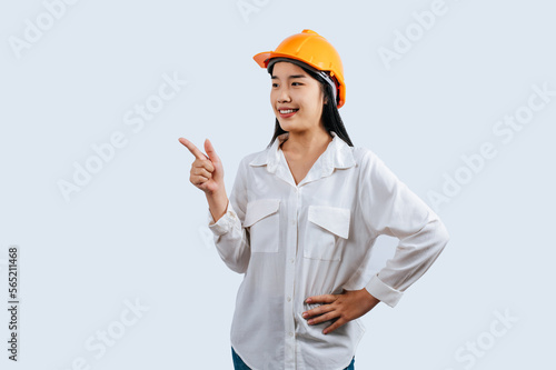 Young female engineer in helmet stand with thumb up posture
