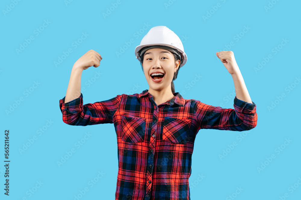 Young asian engineer female wearing helmet raise two hand with glad