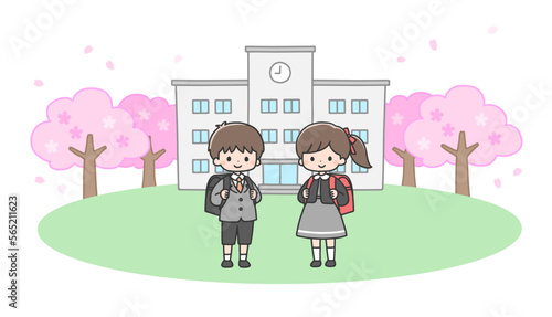 入学式　校舎の前に立つ新一年生の男の子と女の子