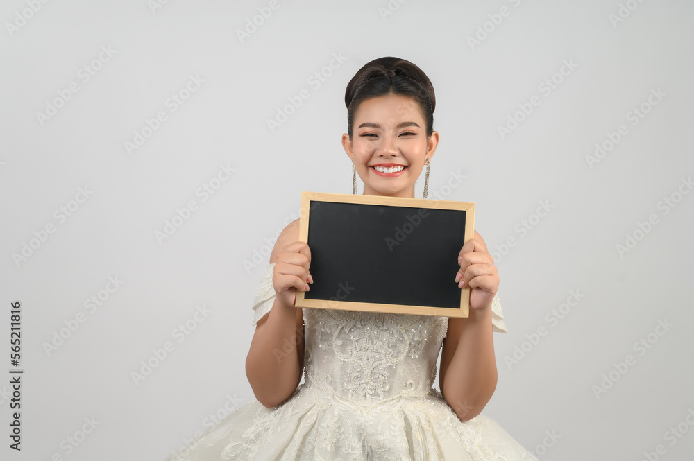 Young asian beautiful bride pose with blank blackboard in hand Young asian beautiful bride pose with blank blackboard in hand