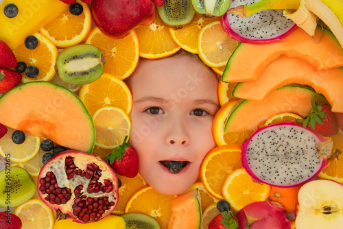 Vitamins from fruits. Mix of fruits near kids face. Assorted mix of summer fresh fruits. Healthy nutrition for kids.