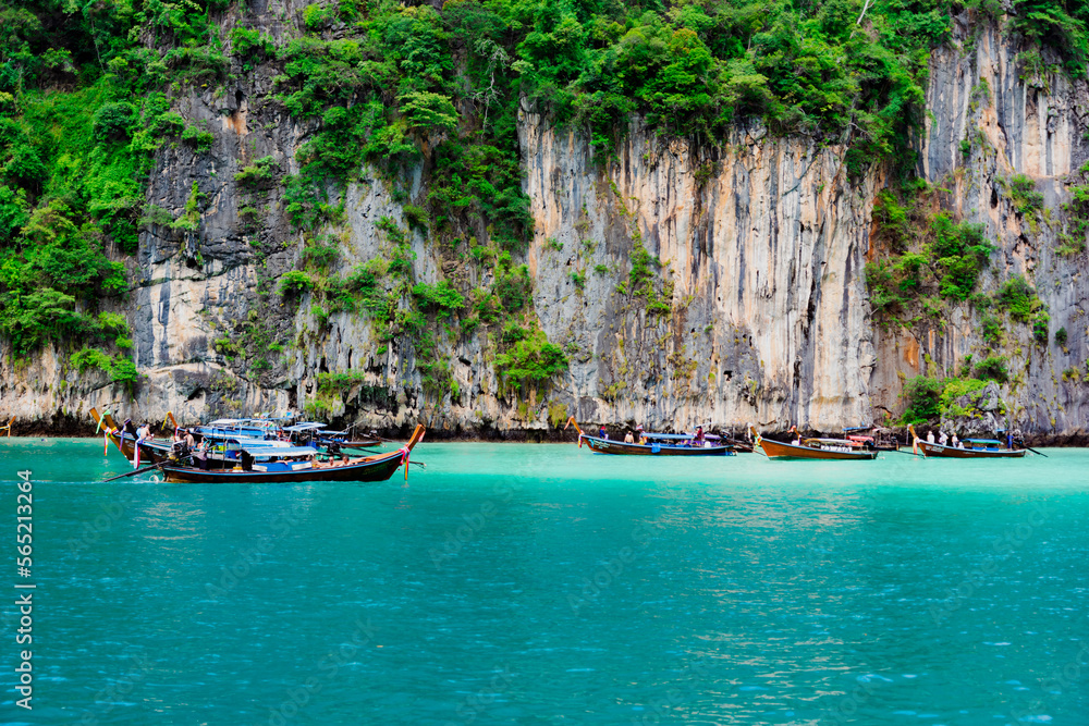 Limestone rocks, clear turquoise water, speedboats in the Pileh Lagoon, Phi Phi, Thailand. Limestone rocks, clear turquoise water, speedboats in the Pileh Lagoon, Phi Phi, Thailand.
