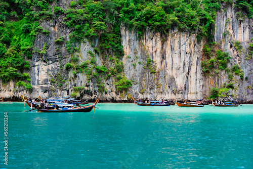 Limestone rocks, clear turquoise water, speedboats in the Pileh Lagoon, Phi Phi, Thailand. 