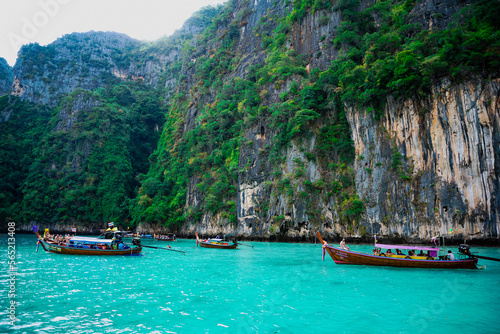Limestone rocks, clear turquoise water, speedboats in the Pileh Lagoon, Phi Phi, Thailand. 