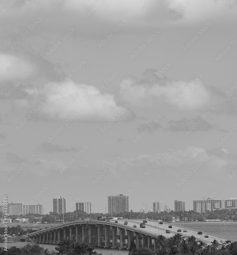 timelapse of clouds over city bridge black and white miami 