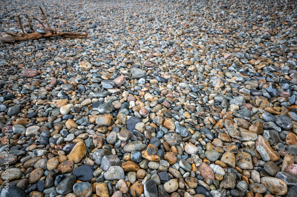 Multi-colored round rocks on Little Hunters Beach in Acadia National Park, Maine. Tide coming in as waves crash. Multi-colored round rocks on Little Hunters Beach in Acadia National Park, Maine. Tide coming in as waves crash.