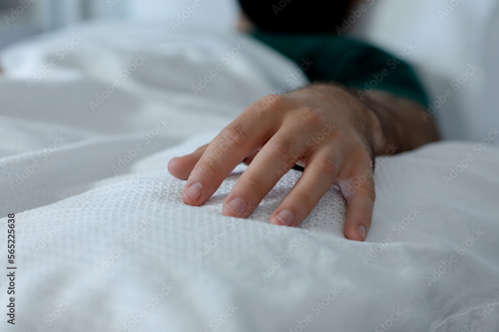 Close up of caucasian male patient lying in bed at hospital Close up of caucasian male patient lying in bed at hospital