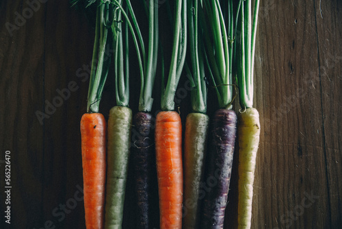 Close-up of colorful carrots on wooden table photo