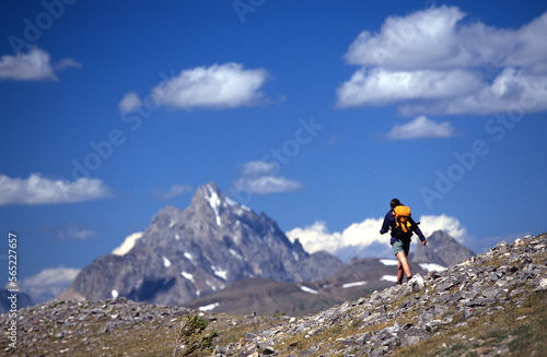 Woman backpacking along a rocky ridge.