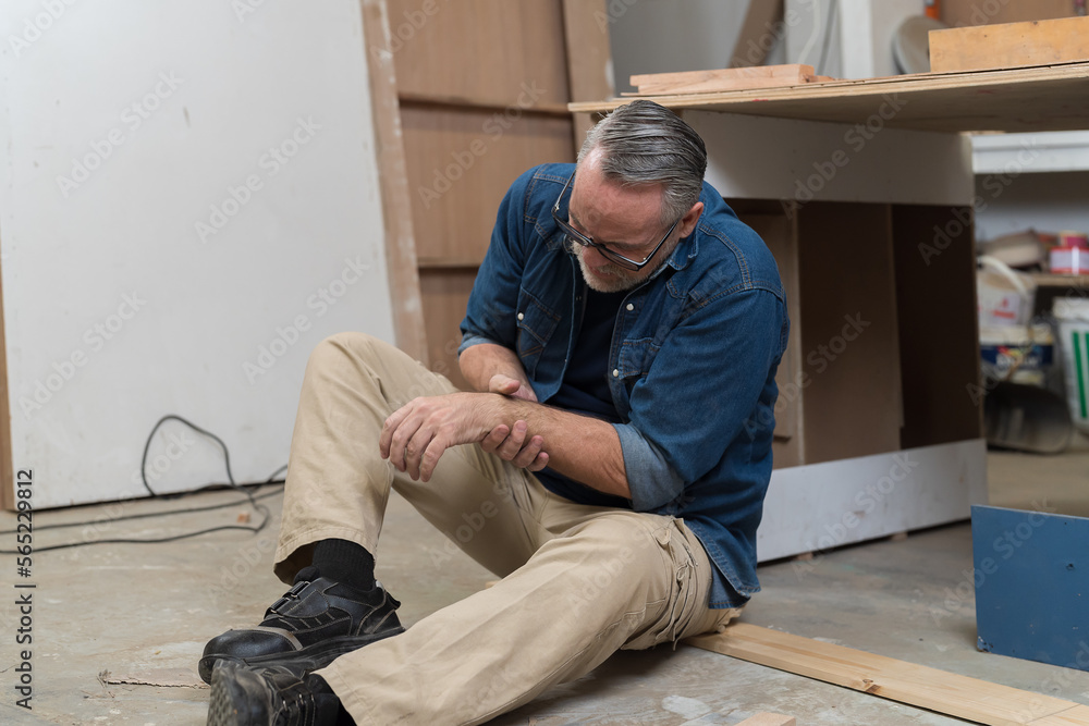 Male carpenter worker accident at his arm in the wood workshop industry factory. Health insurance concept Male carpenter worker accident at his arm in the wood workshop industry factory. Health insurance concept