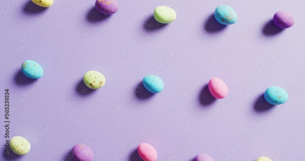 Close up of multiple colorful easter eggs on purple background Close up of multiple colorful easter eggs on purple background