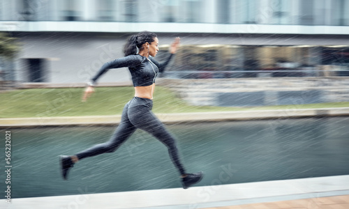 Sprinting, fast and woman running in the city for fitness, training and morning energy in Germany. Exercise, sports and athlete runner with focus during outdoor cardio for body performance in motion