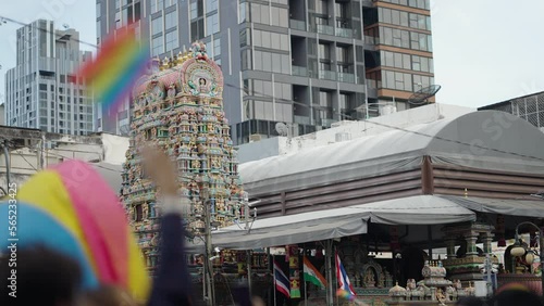 People Raising And Waving Pride Flags With Sri Maha Mariamman Temple (Wat Khaek) In The Background In Bangkok, Thailand. - wide photo