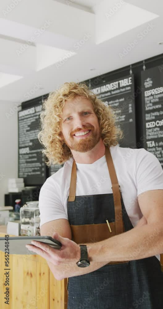Vertical video of portrait of happy caucasian male barista in his cafe shop Vertical video of portrait of happy caucasian male barista in his cafe shop