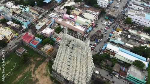 Fly over Hindu temple tower and suburban city. Aerial view of Sri Kanchi Kamakshi Amman Temple, Kanchipuram, Tamil Nadu. photo