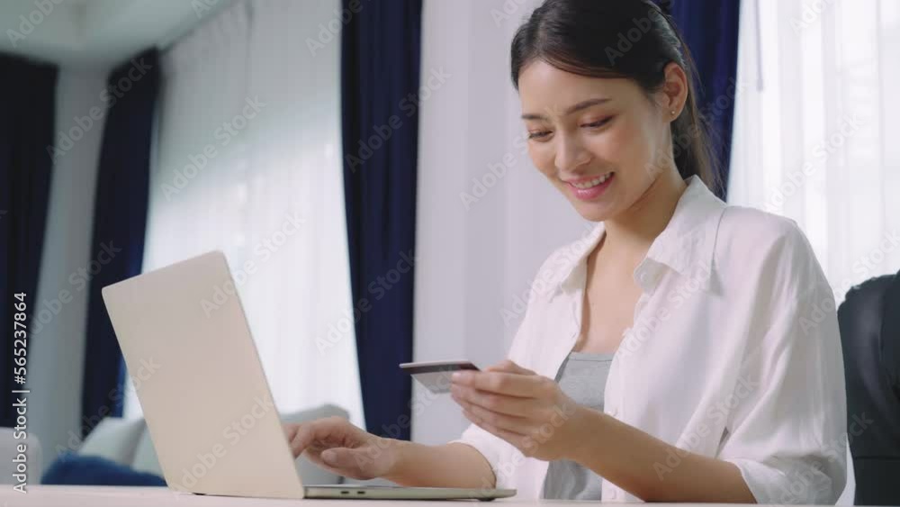 Young asian woman makes online banking payments through the internet from bank card on computer laptop. Shopping online on notebook with credit card Young asian woman makes online banking payments through the internet from bank card on computer laptop. Shopping online on notebook with credit card