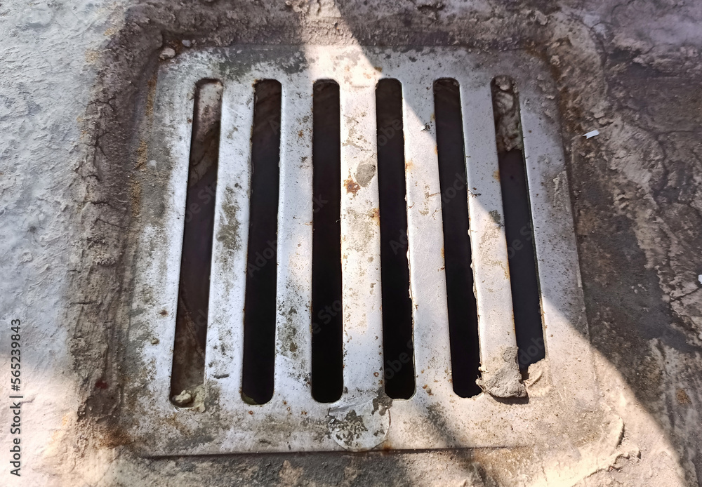 Drainage hatch on the street. View from above, top view.