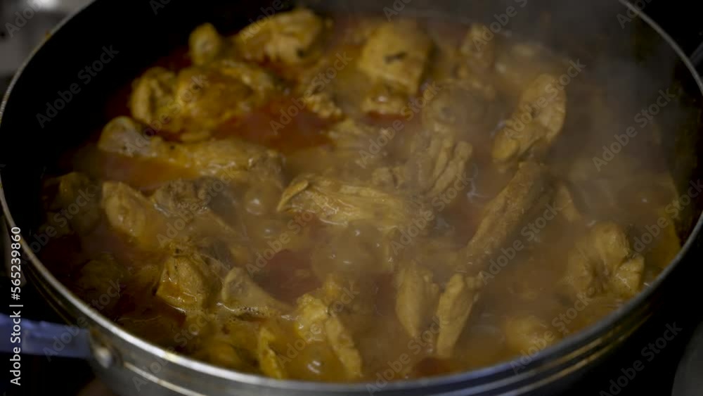 Steam Rising From Bubbling Chicken Curry In Pan . Slow Motion