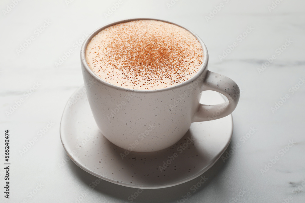 Delicious eggnog with cinnamon on white marble table, closeup Delicious eggnog with cinnamon on white marble table, closeup