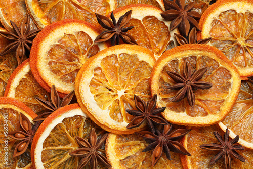 Dry orange slices and anise stars as background, top view