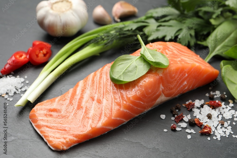 Fresh salmon and ingredients for marinade on black table, closeup Fresh salmon and ingredients for marinade on black table, closeup