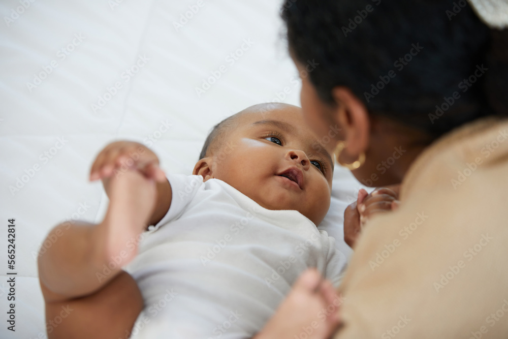 African adorable baby looking mother on bed African adorable baby looking mother on bed