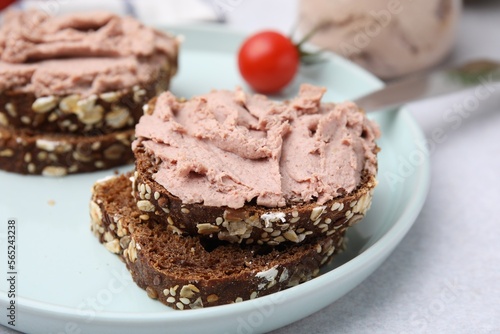 Slices of bread with delicious liverwurst on white table, closeup