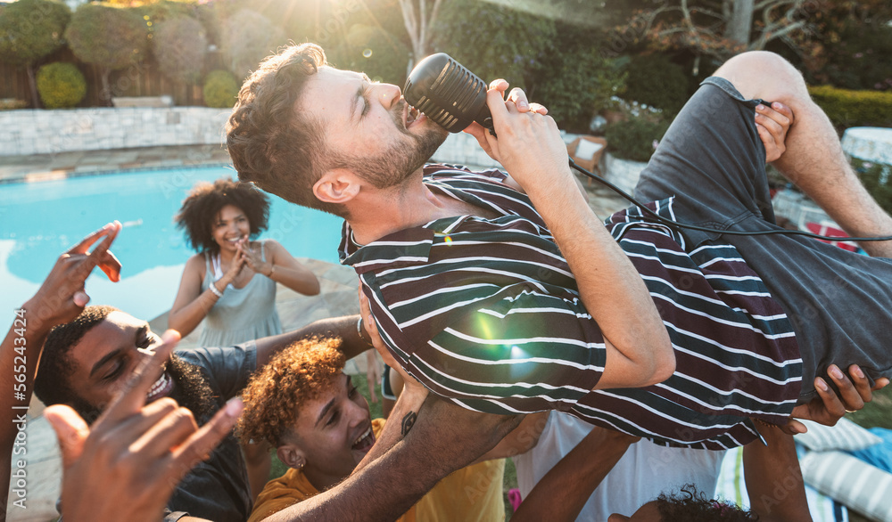 Microphone, singing and crowd surfing with a man performer at a party ...