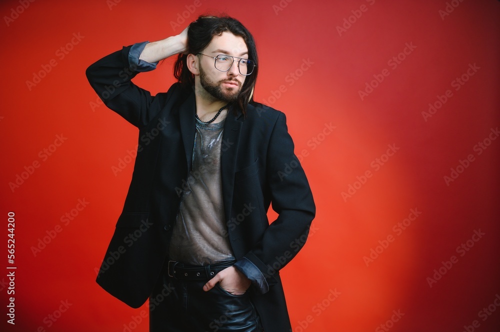 Young gay man is standing in the studio and posing for a camera. Young gay man is standing in the studio and posing for a camera.