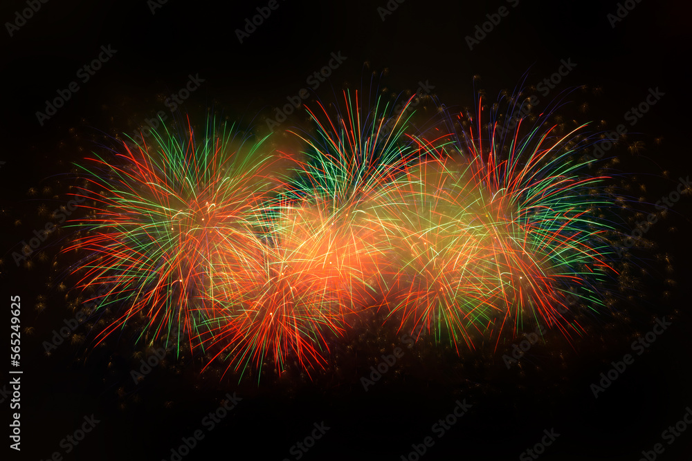 Beautiful colorful fireworks display lights up the sky with dazzling display during New Year celebration. Abstract colored fireworks background with copy space. Celebration and anniversary concept
