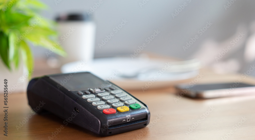 close credit card payment machine at table with white coffee cup on table in the cafe , contactless pay concept close credit card payment machine at table with white coffee cup on table in the cafe , contactless pay concept