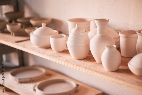 Ceramics background, shelf and pottery in studio, creative store or manufacturing startup. Clay design, collection and display in workshop, small business and retail craft market of stock production