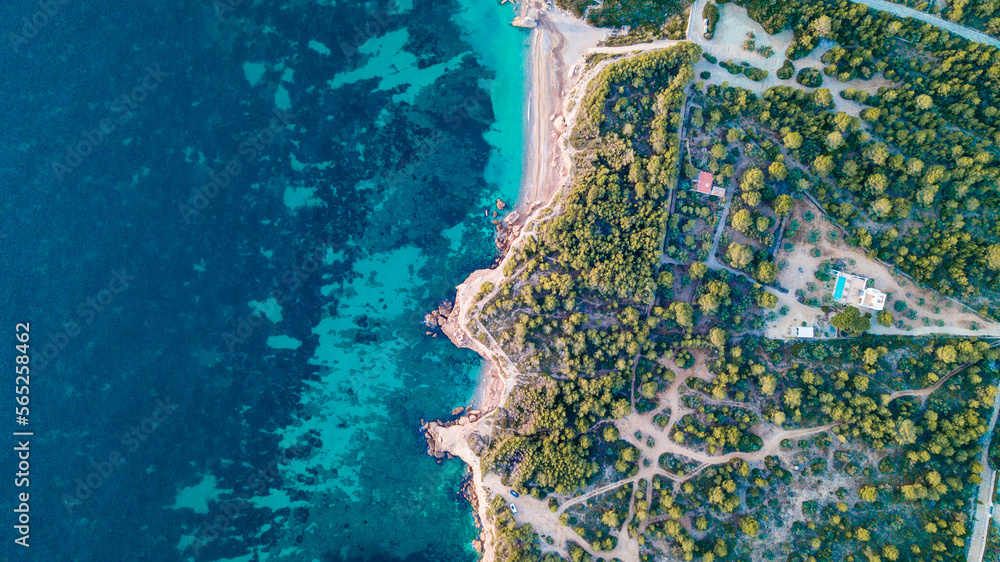 drone shot from nearby barcelonas bay area in spain with beach green trees and cyan blue water