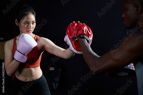 sportswoman or fighter training boxing in the gym
